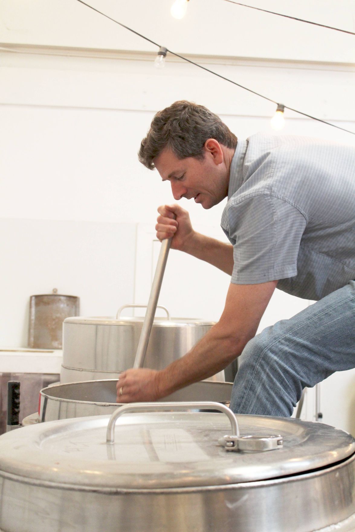 Nile Zacherle pushes down the mash at Mad Fritz Brewing in St. Helena